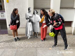 Three people standing around Claire Waldoff in Augmented Reality